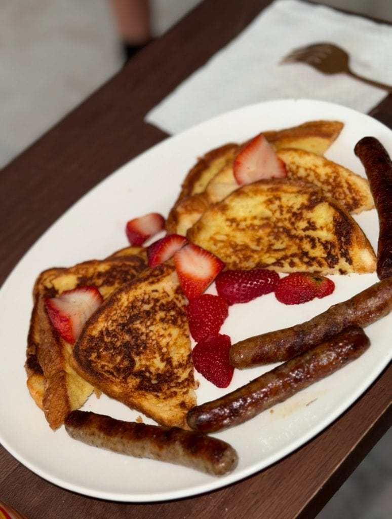 Mother’s Day breakfast of French toast, strawberries, and sausage, symbolizing small moments of joy and love while healing through grief.
