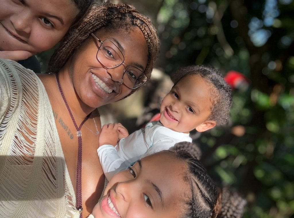 Widowed mom smiling with her children, proof that healing isn’t linear but family love creates strength.