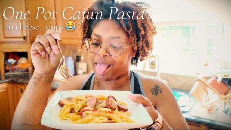 LaNolaMom holding plate of one pot Cajun sausage pasta — Soulful Rituals Ep 2